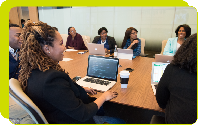 About-Home-Hero-900×500 Colleagues meeting around a conference table