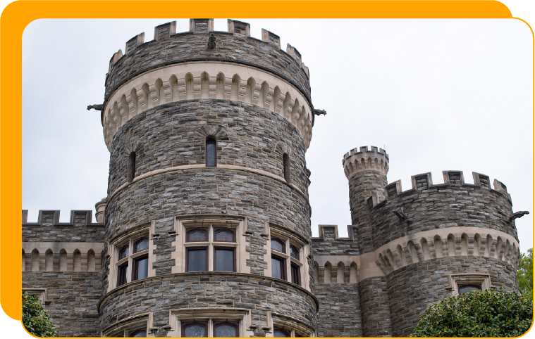 CaseStudy-HomePage-InstitutionImage-900×500 A historic stone building on a college campus